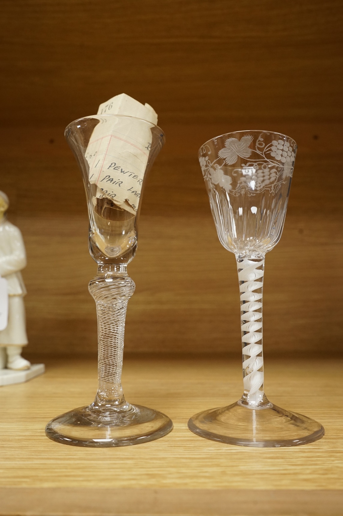 Two Georgian wine glasses, one with air twist stem and etched decoration to the bowl, largest 16cm high